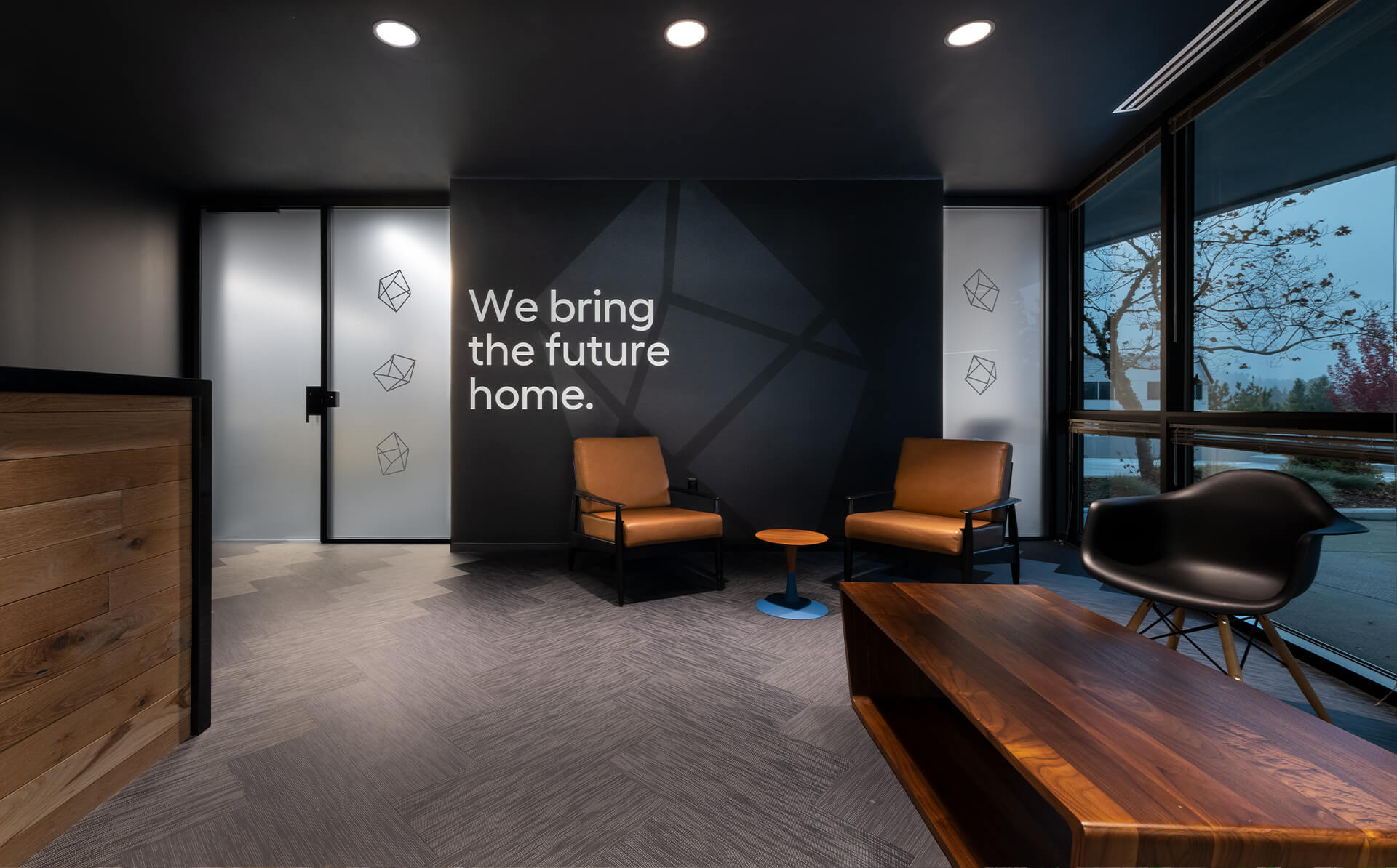 Image of Lowes Innovation Labs office lobby in Kirkland, Washington, with our tagline on the wall that reads 'we bring the future home'