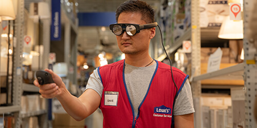 Store associate in a store aisle, wearing an AR headset used to assist in visualizing the Store Digital Twin in realtime.
