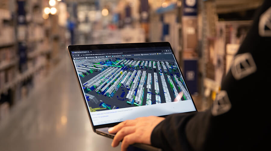 Lowe's Innovation Labs team member checking the Babylon Digital Twin on laptop while in a Lowes Home Improvement store.