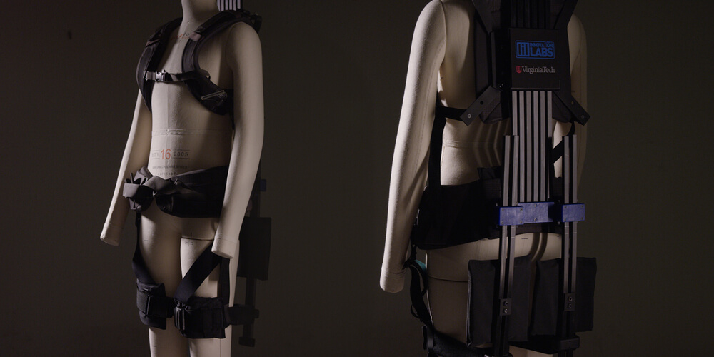 Front and back view of mannequin modeling soft robotic exoskeleton.