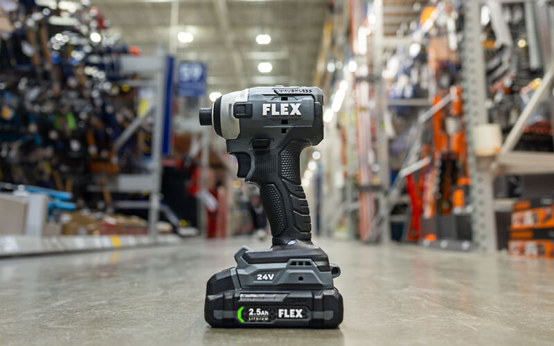 Flex brand drill sitting in the aisle of a Lowes Home Improvement. 